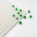 Angled view of a 1mL cube gummy mold with emerald green cube gummies
