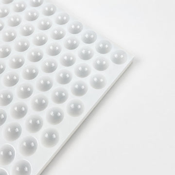 Close-up of 2.6mL hemisphere cavities in a commercial silicone gummy mold