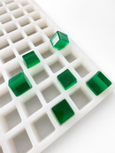 Stampo per gummies a cubetti da 2.85 mL, 315 cavità — vista angolata con gummies traslucide verde smeraldo