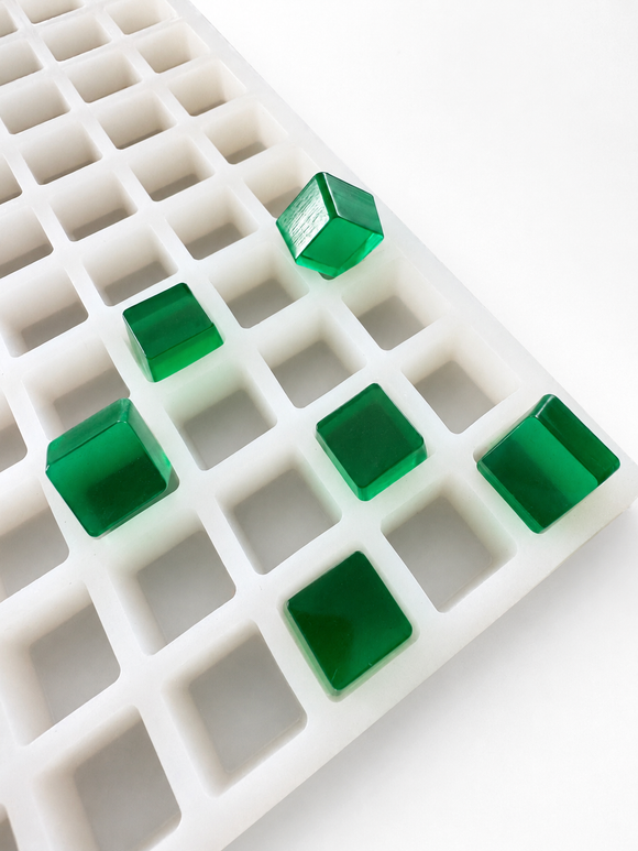 Stampo per gummies a cubetti da 2.85 mL, 315 cavità — vista angolata con gummies traslucide verde smeraldo