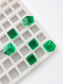 Primo piano dello stampo per gummies a cubetti da 2.85 mL a 315 cavità, con profondità e gummies verdi