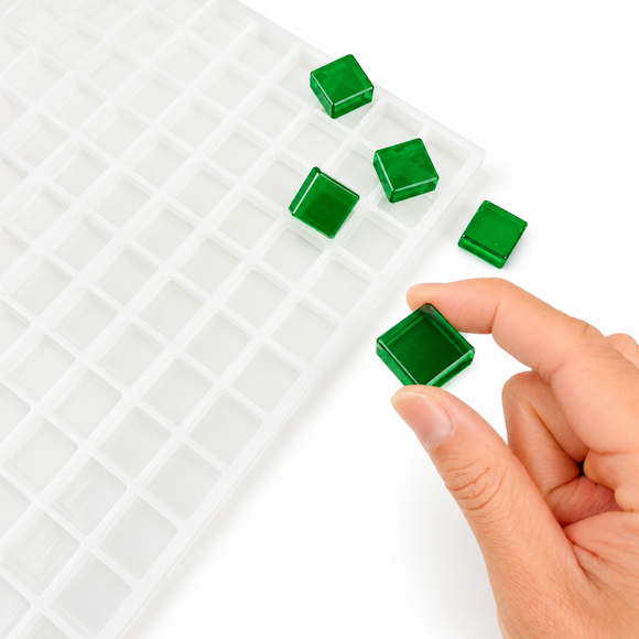 Finished 3.5mL square gummy held beside the 221-cavity mold